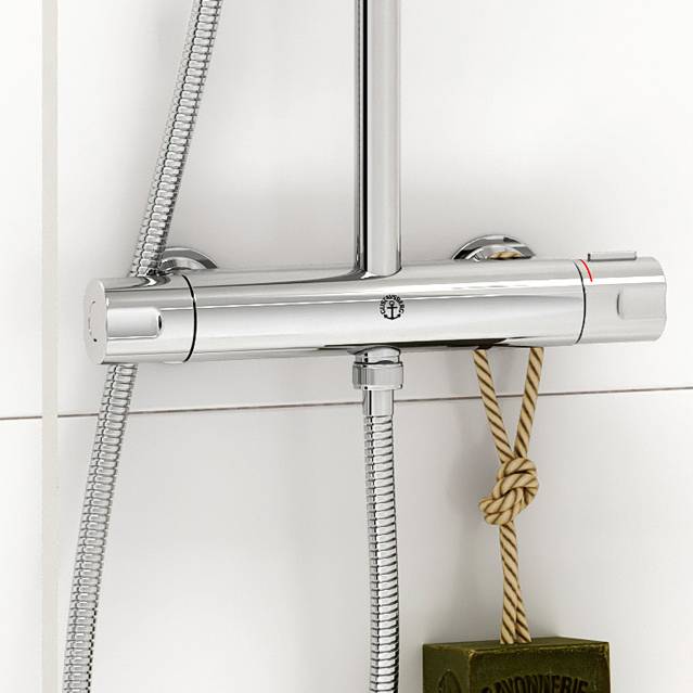 Chrome shower mixer with a dark green soap hanging from a braided rope attached to it.