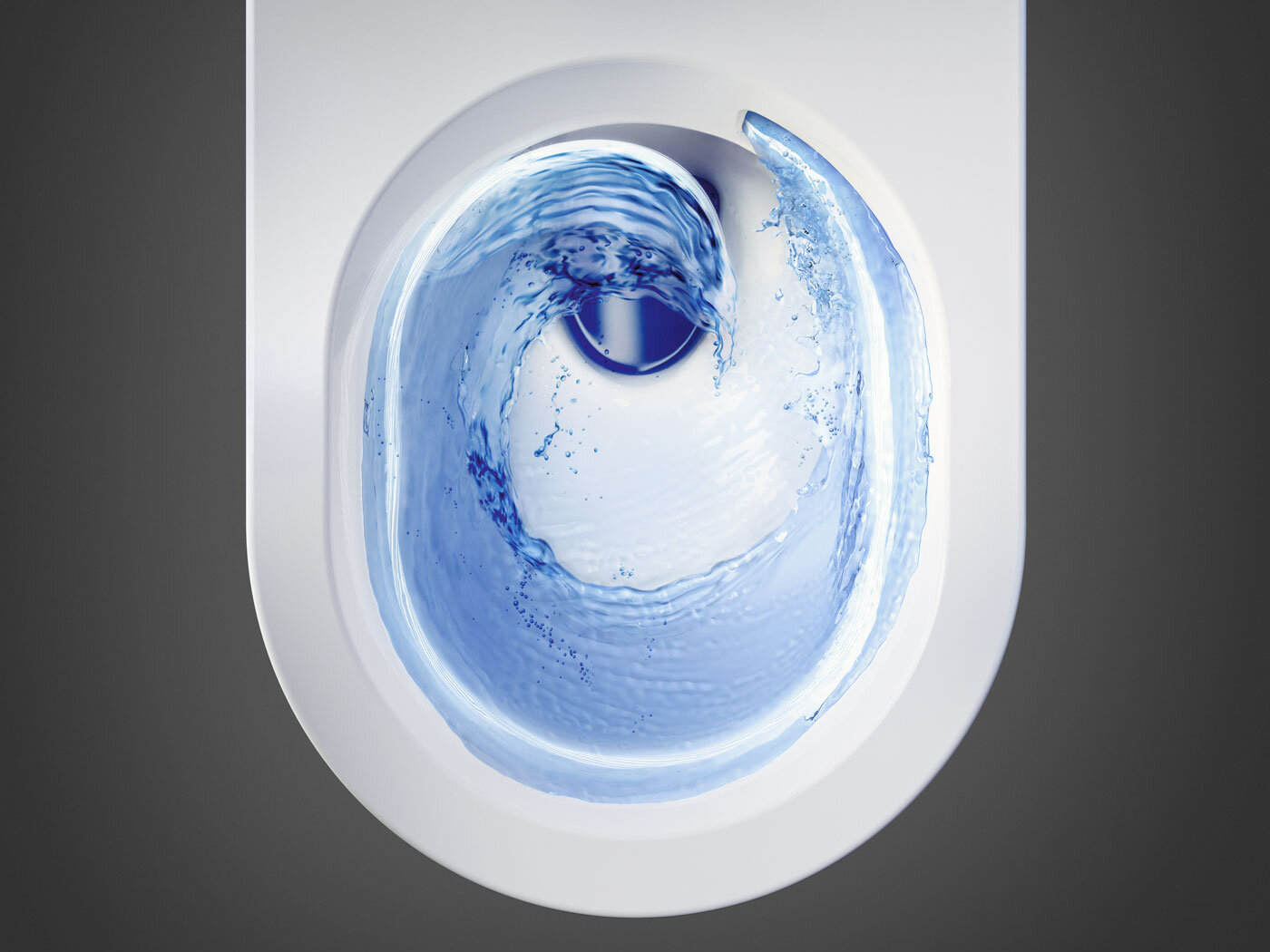 WC-istuin ylhäältä katsottuna, huuhtelu luo pyörteitä veteen.