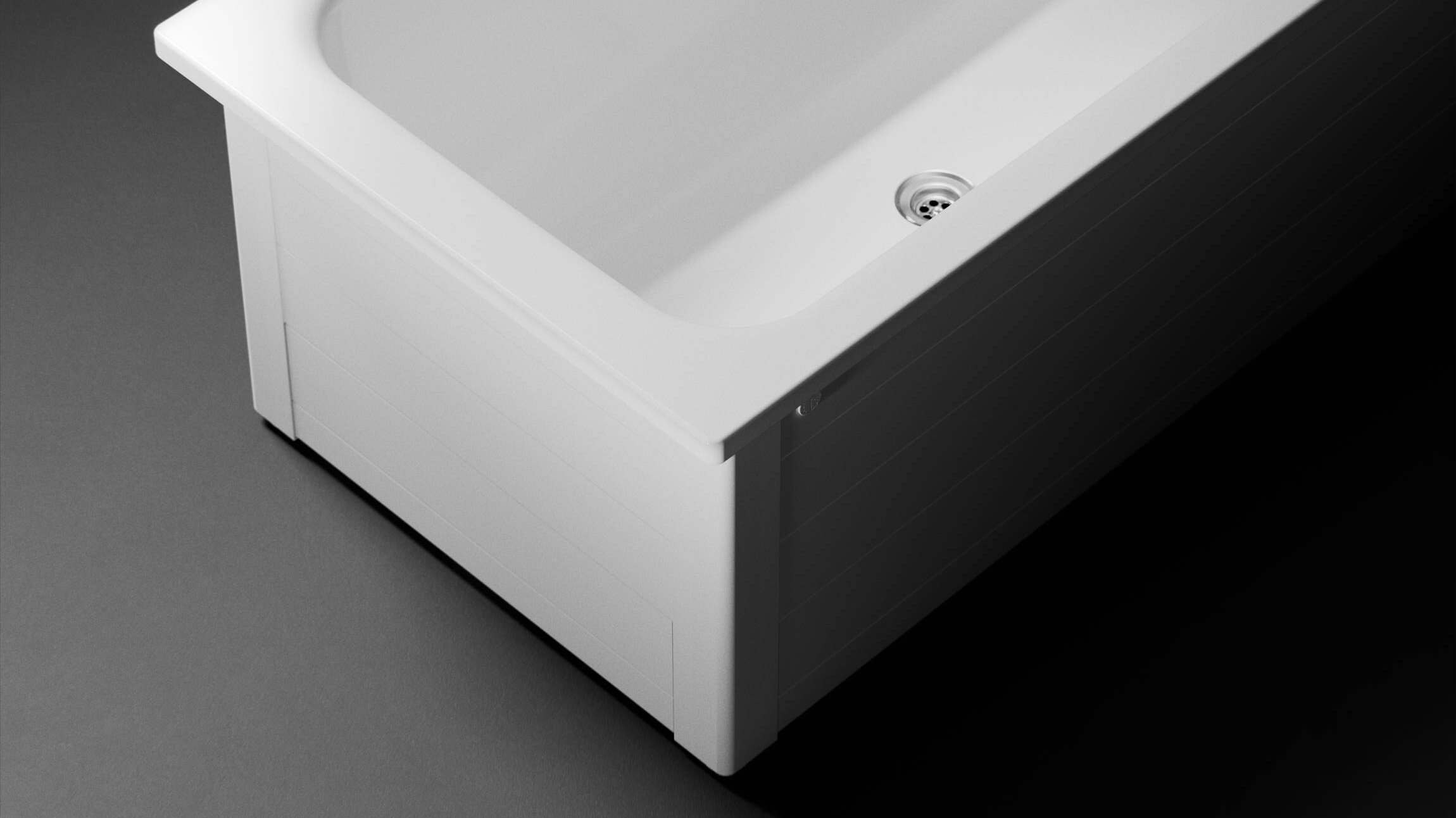 A white rectangular Gustavsberg bathtub with a visible drain, set against a dark background. Vonios
