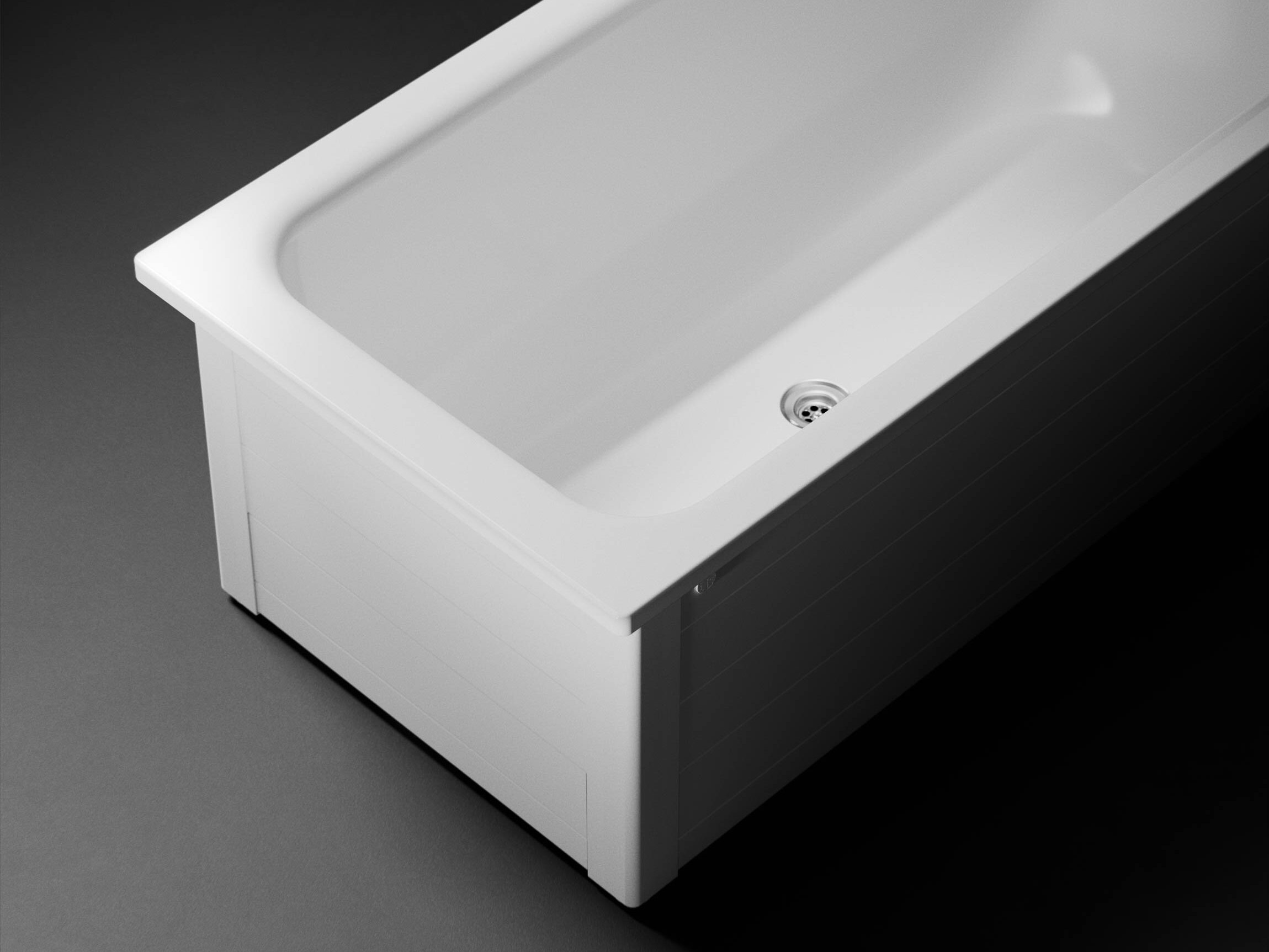 A white rectangular Gustavsberg bathtub with a visible drain, set against a dark background. Gustavsbergin kylpyamme